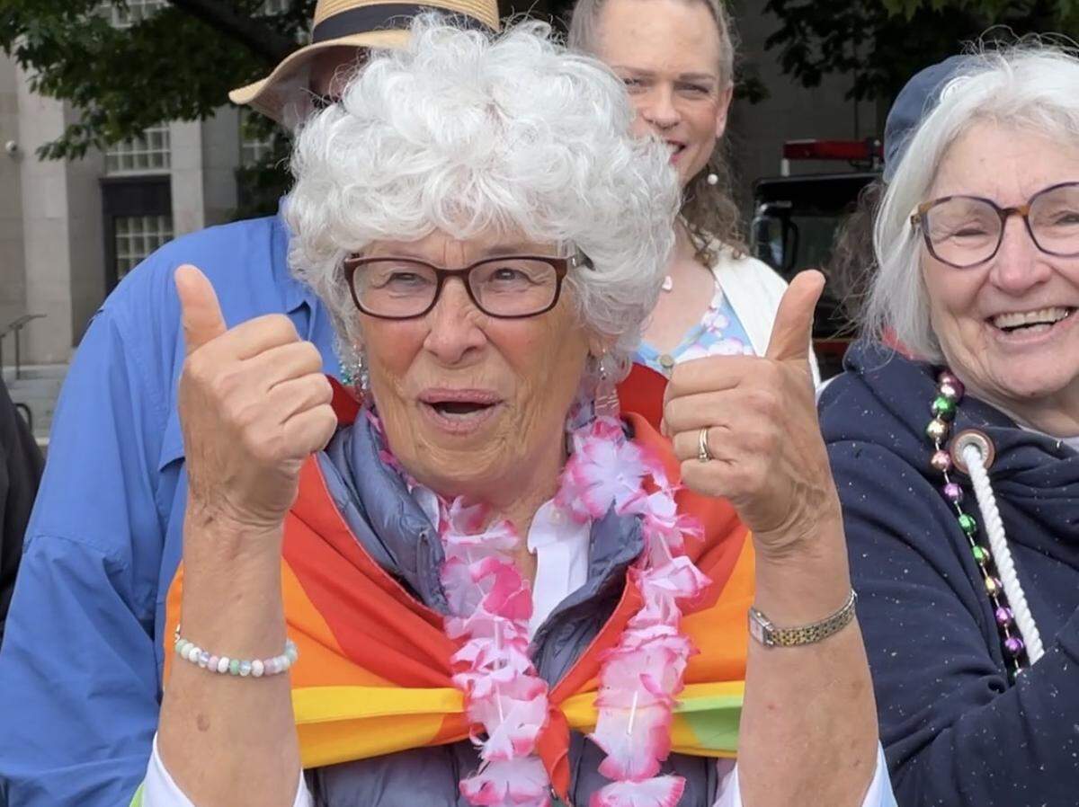 A spectator cheers participants in the Whatcom Youth Pride parade Saturday in downtown Bellingham.