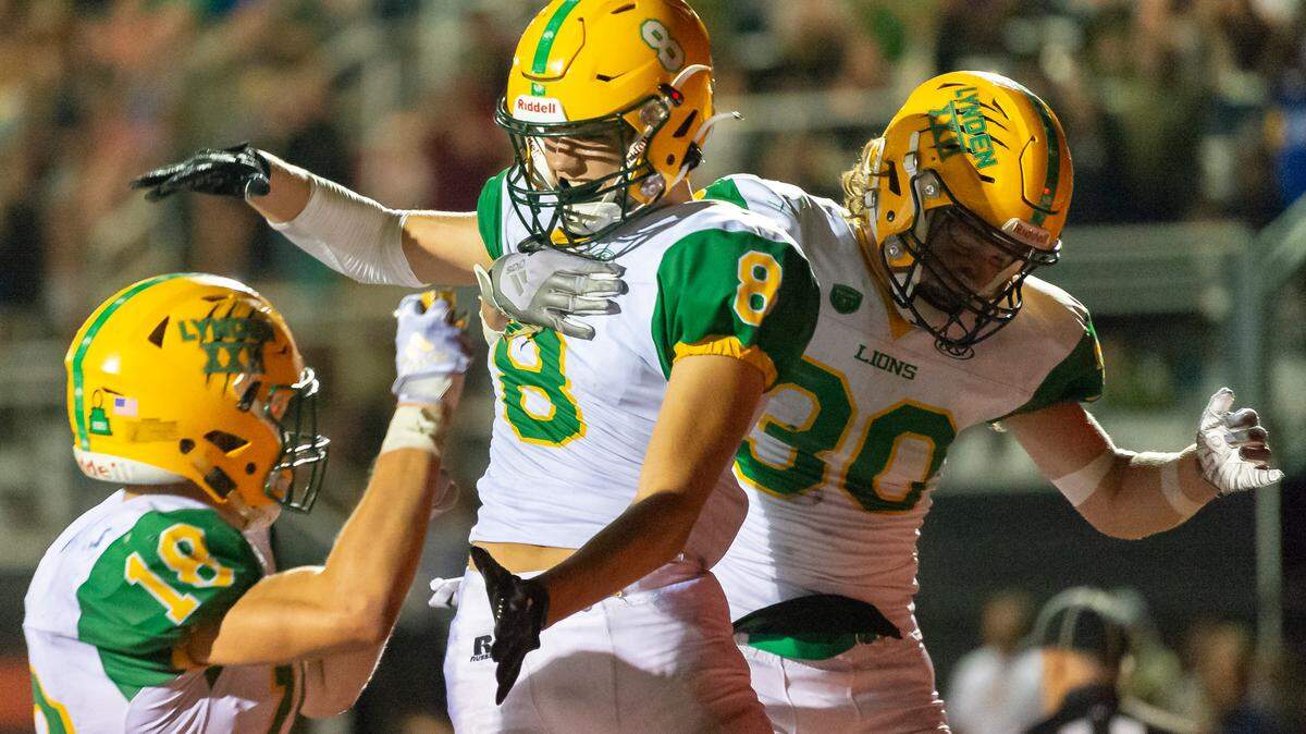 Lynden teammates Colin Anker (18), left, and Isaiah Oudman (30) celebrate with Isaiah Stanley (8) after scoring a touchdown in the fourth quarter on Friday evening Sept. 2 at Blaine High School.