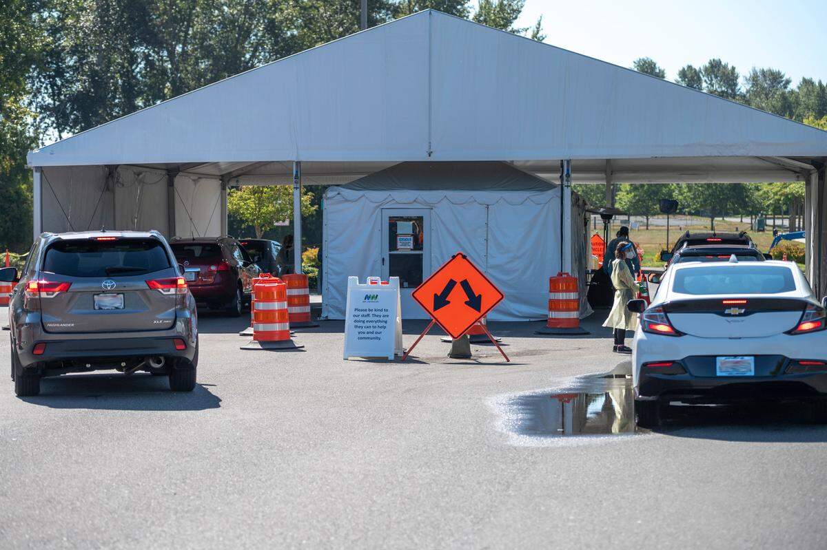 People wait to be tested for COVID-19 at a testing site operated by Northwest Laboratory at Bellingham International Airport on Thursday, Sept. 2.