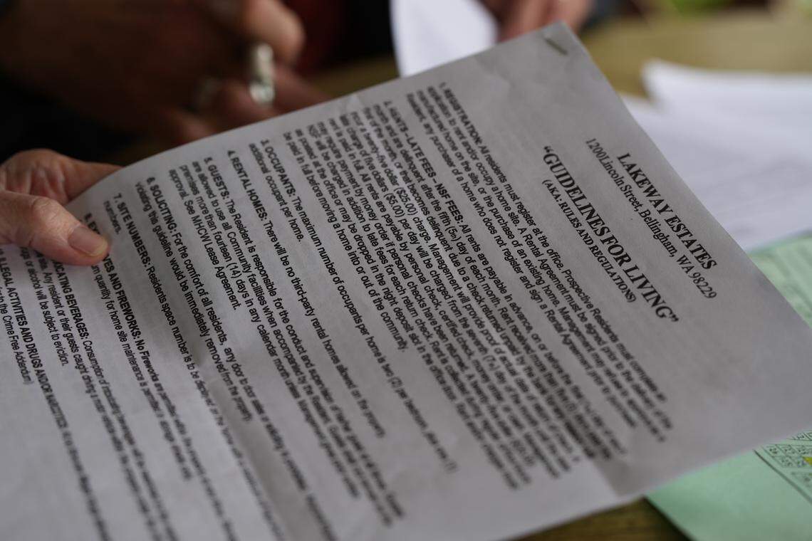 A resident of Lakeway Estates reads the manufactured home park’s “Guidelines For Living.”