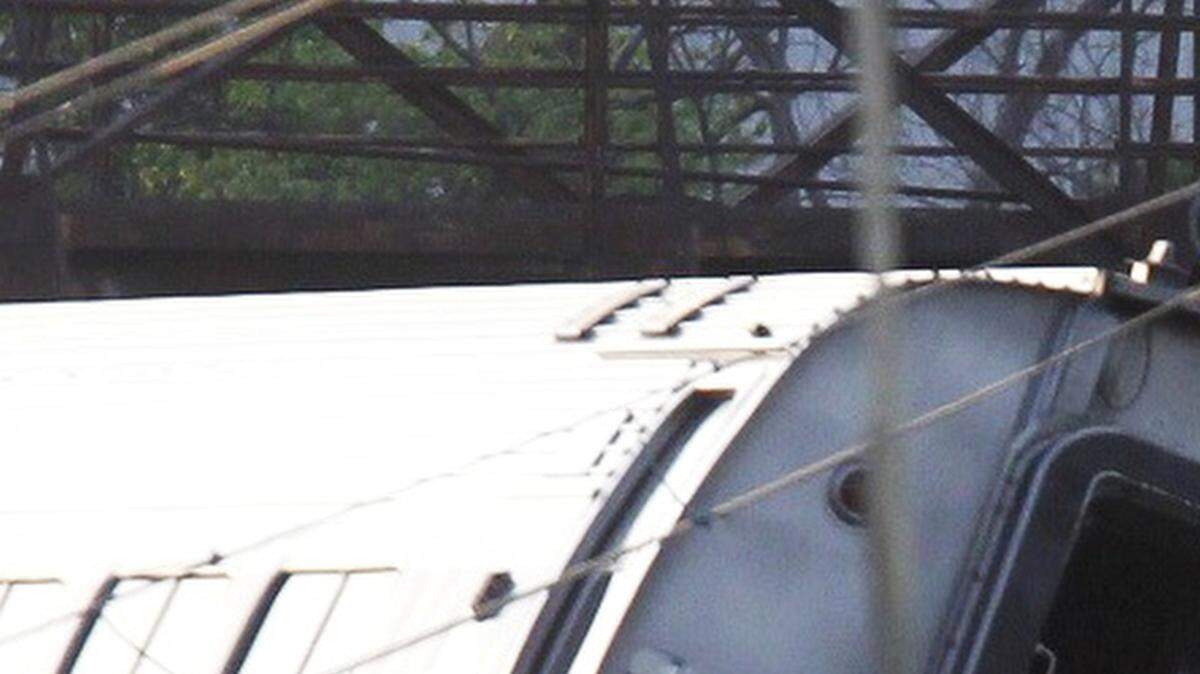 Investigators examine the train derailment site on Wednesday, May 13, 2015, after a northbound Amtrak train crashed in the Port Richmond area of Philadelphia Tuesday night. The train jumped the tracks at 106 mph on a curve limited to 50 mph. Eight people were killed.