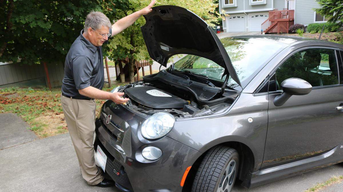 Sudden Valley resident Don Minter lifts the hood of his electric vehicle at his home near Bellingham on Friday, July 16.