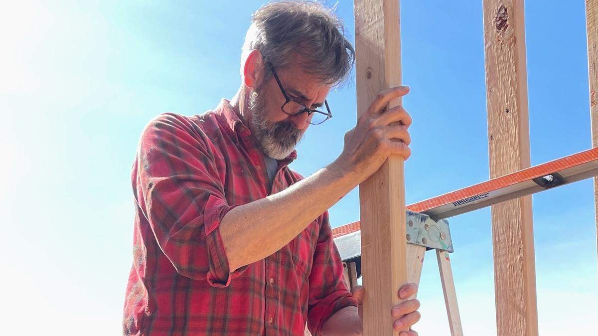 Bellingham City Council member Michael Lilliquist helps frame one of the tiny homes being built by volunteers for the new North Haven tiny home village on Northwest Avenue in Bellingham, Wash.