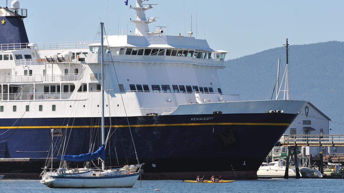 The MV Kennicott dwarfs a pair of kayakers as it is moored at the Bellingham Cruise Terminal in Fairhaven in 2013.  It appears the Alaska ferry will continue to provide service out of Bellingham this winter, but at a reduced level.