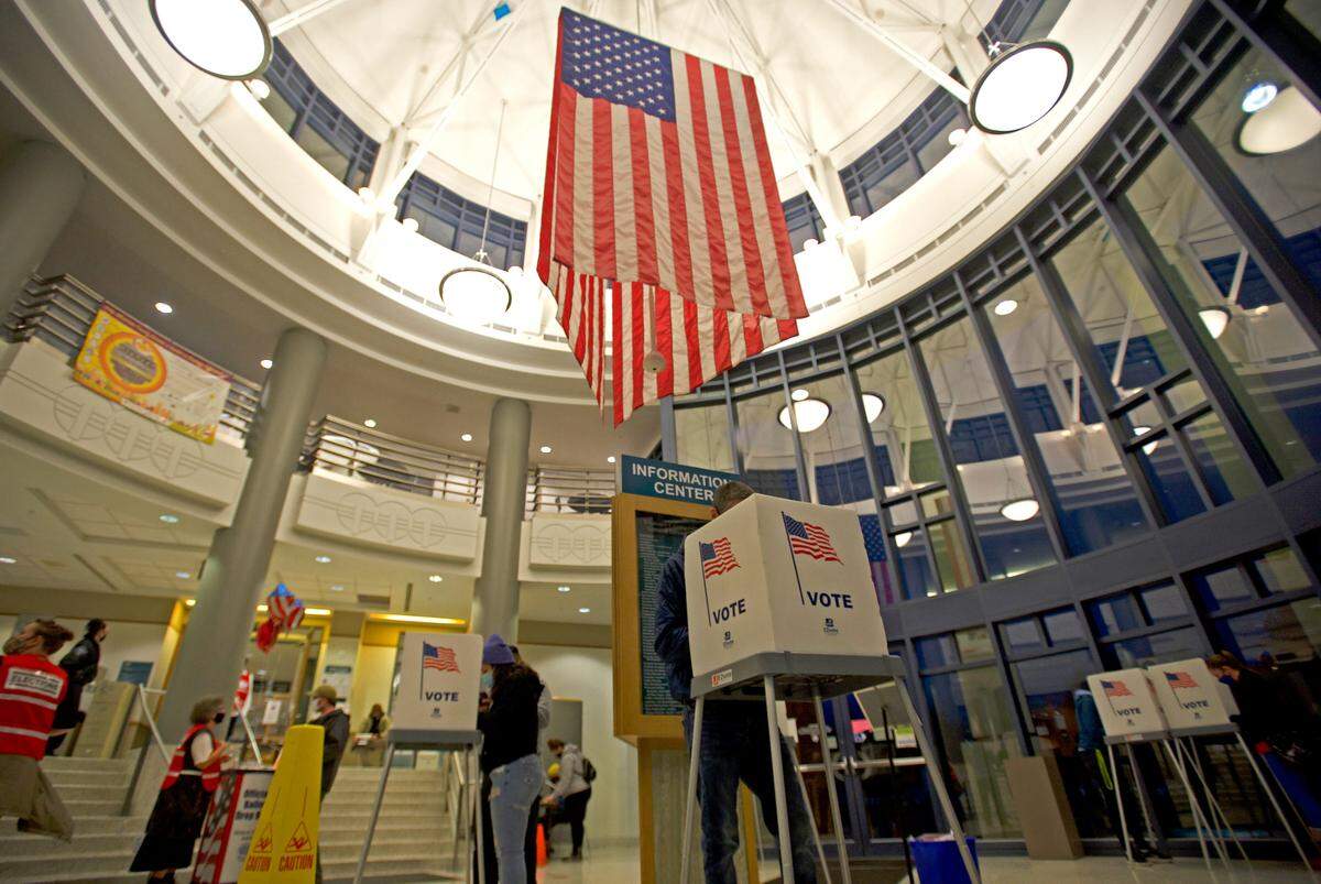 People fill out ballots in the rotunda of the Whatcom County Courthouse during the U.S. 2020 general election on Tuesday, Nov. 3, in Bellingham.