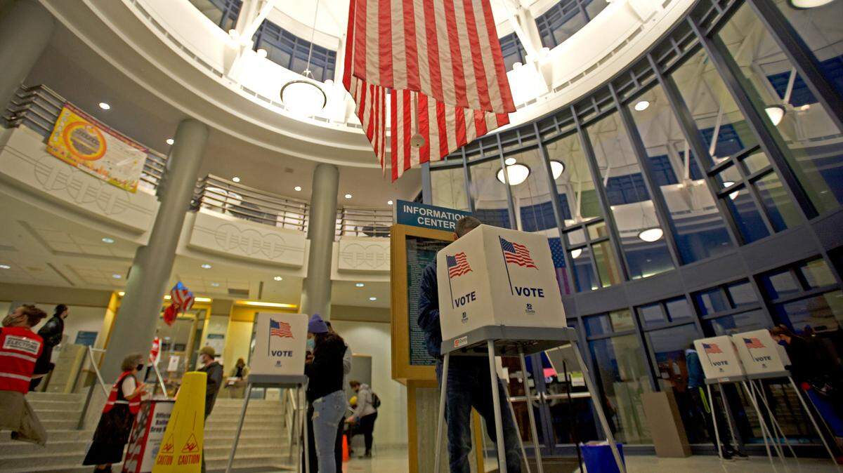 People fill out ballots in the rotunda of the Whatcom County Courthouse during general election in 2020.