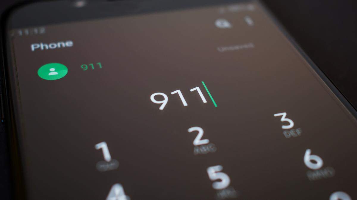 Emergency 911 call on smartphone, mobile phone, close up