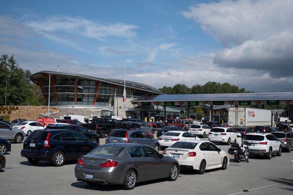 Cars line up while waiting to enter Canada from the U.S. at the Peace Arch Park border crossing on Monday, Aug. 9, 2021, in Blaine, Wash. Canada allowed U.S. citizens to travel to the county for reasons it has previously deemed non-essential for the first time in 17 months due to the COVID-19 pandemic.