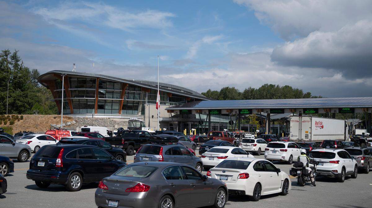 Cars line up while waiting to enter Canada from the U.S. at the Peace Arch Park border crossing in Blaine, Wash. Canada is Washington state’s top trade partner but new tariffs could affect that.