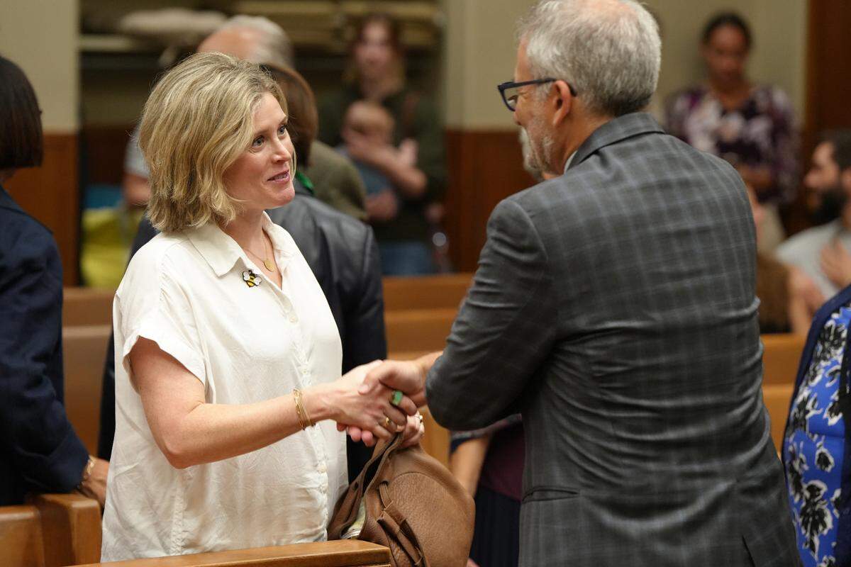 Chuckanut Health Foundation Board President Erin Lynch shakes the hand of lawyer Knoll Lowney, who represented the group Protect Whatcom Kids in a case to prevent an initiative from appearing on the Nov. 5, 2024, ballot that would have asked voters to repeal a tax that funds child-care programs in Whatcom County.