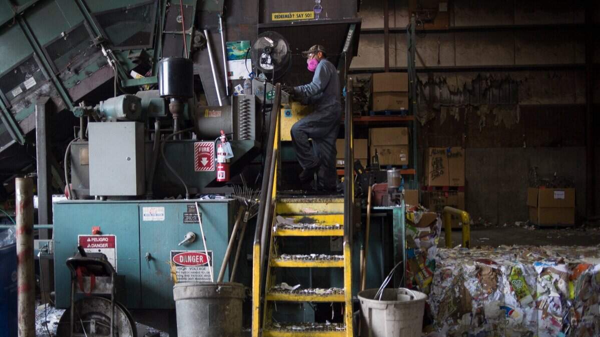 Flavio Pena uses a baler to press recycled paper into bales weighing about 1,300 pounds each at Northwest Recycling, Inc. in 2019 in Bellingham. Bellingham trash and recycling hauler Sanitary Service Co. is considering a switch to single-bin recycling in an effort to get more people to stop discarding items that could be reused.