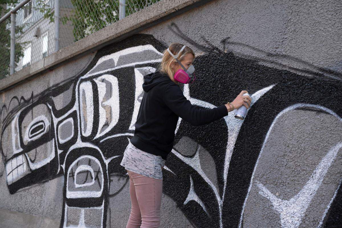 Muralist Gretchen Leggitt works on a new mural on Forest Street on Thursday, Sept. 2, in Bellingham.