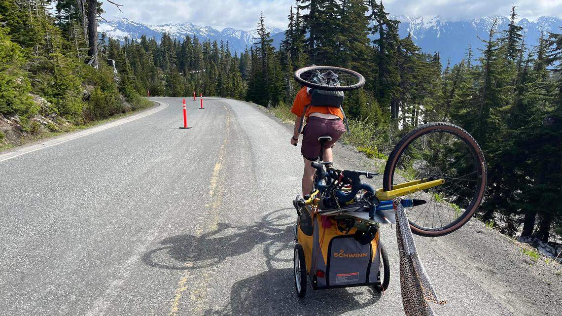 James Schneider, riding down from the ski legs carrying the runners bike.