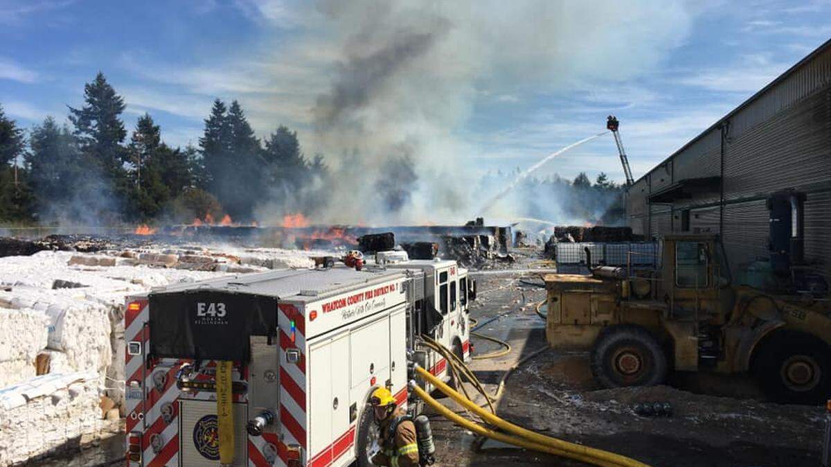 Firefighters from across Whatcom County prevented burning paper material from spreading to a nearby business in a two-alarm fire Tuesday, Sept. 7, north of Ferndale.