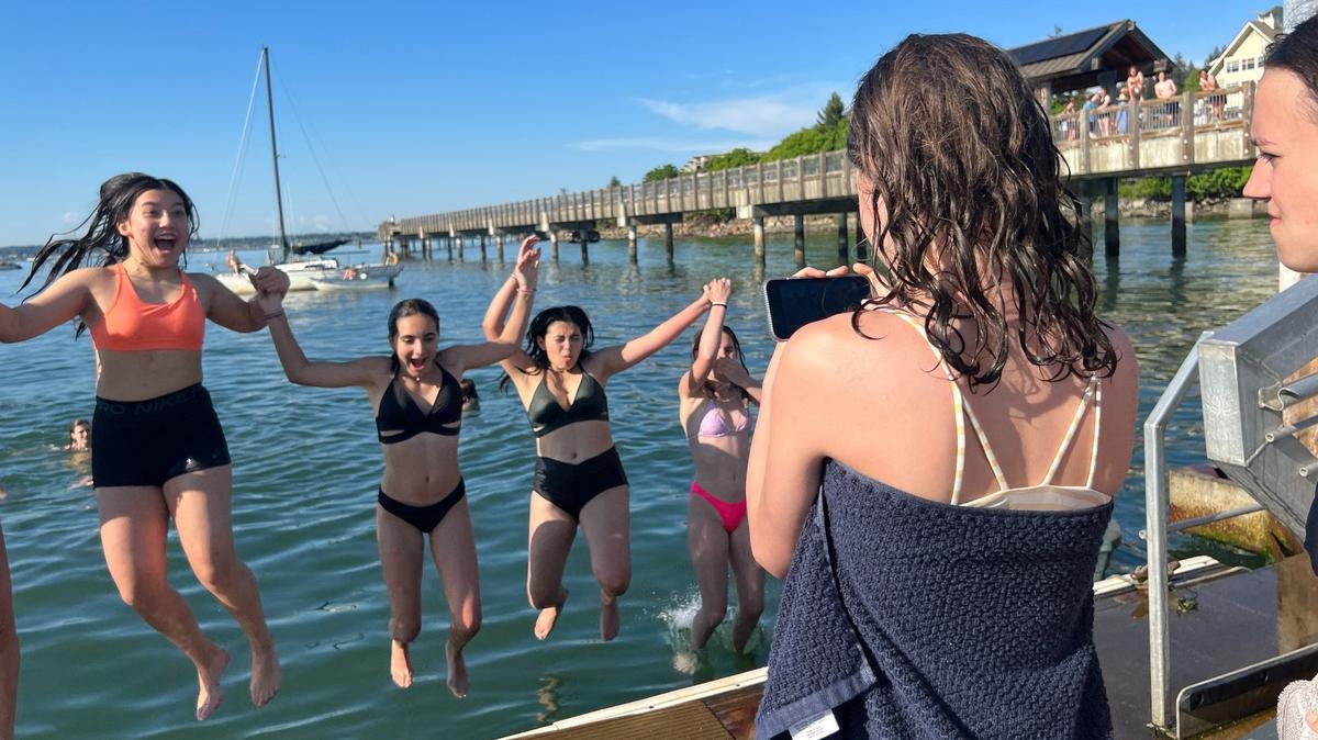 A girl uses her smartphone to snap a photo of her friends jumping into Bellingham Bay near Taylor Dock on May 15. Taylor Dock is a quarter-mile boardwalk over the water from Boulevard Park to the Fairhaven district as part of the South Bay Trail. It was built in 2004-2005 using $1.8 million of Greenways levy funds.