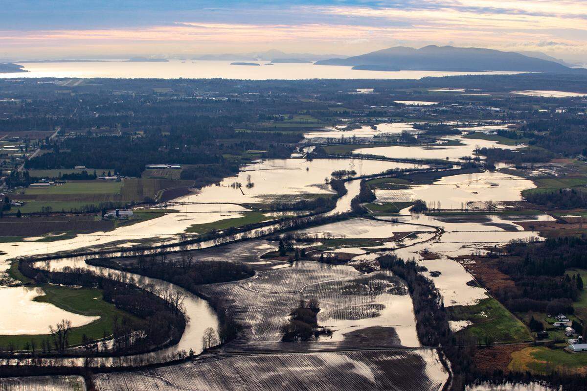 The Nooksack River west of Lynden shows standing water that continues to inundate the farmland to the south along the winding river banks and threatened the Ferndale area with record flooding in November 2021.