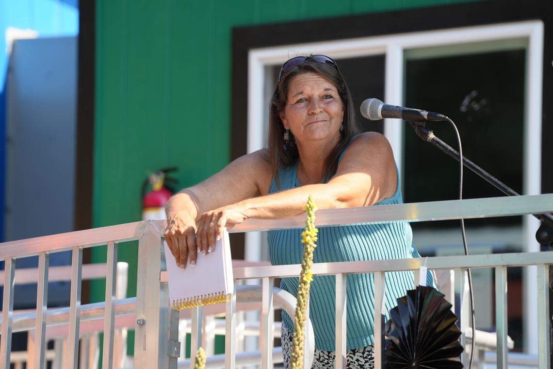 HomesNOW! Not Later Board of Directors Co-Chair Tina Hayes speaks at the grand opening celebration.