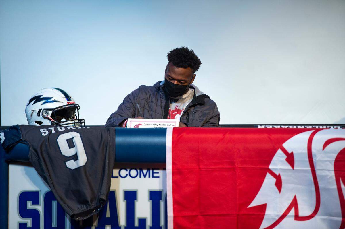 Djouvensky Schlenbaker, who plays running back for Squalicum High School, poses for a photo after signing his letter committing to Washington State University to play football on Wednesday, Dec. 15, 2021, in Bellingham, Wash.