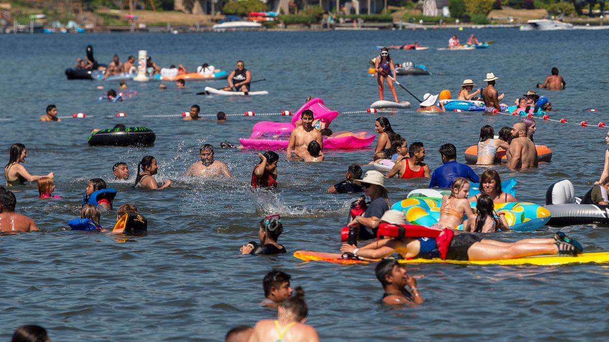 Hundreds pack the waters of Lake Whatcom to combat the record heat at Bloedel Donovan Park on Sunday afternoon June 27, 2021, in Bellingham, Wash.