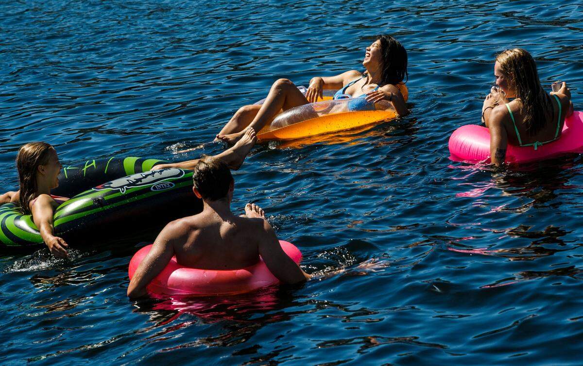 Thea DeBroux , left to right, Matthew Ryan, Anna Matsumoto and Maia Buswell enjoy the water at Lake Union Park, Thursday, June 24, in Seattle. The Pacific Northwest sweltered Friday and braced for even hotter weather through the weekend as a historic heat wave hit Washington and Oregon, with temperatures in many areas expected to top out up to 30 degrees above normal.