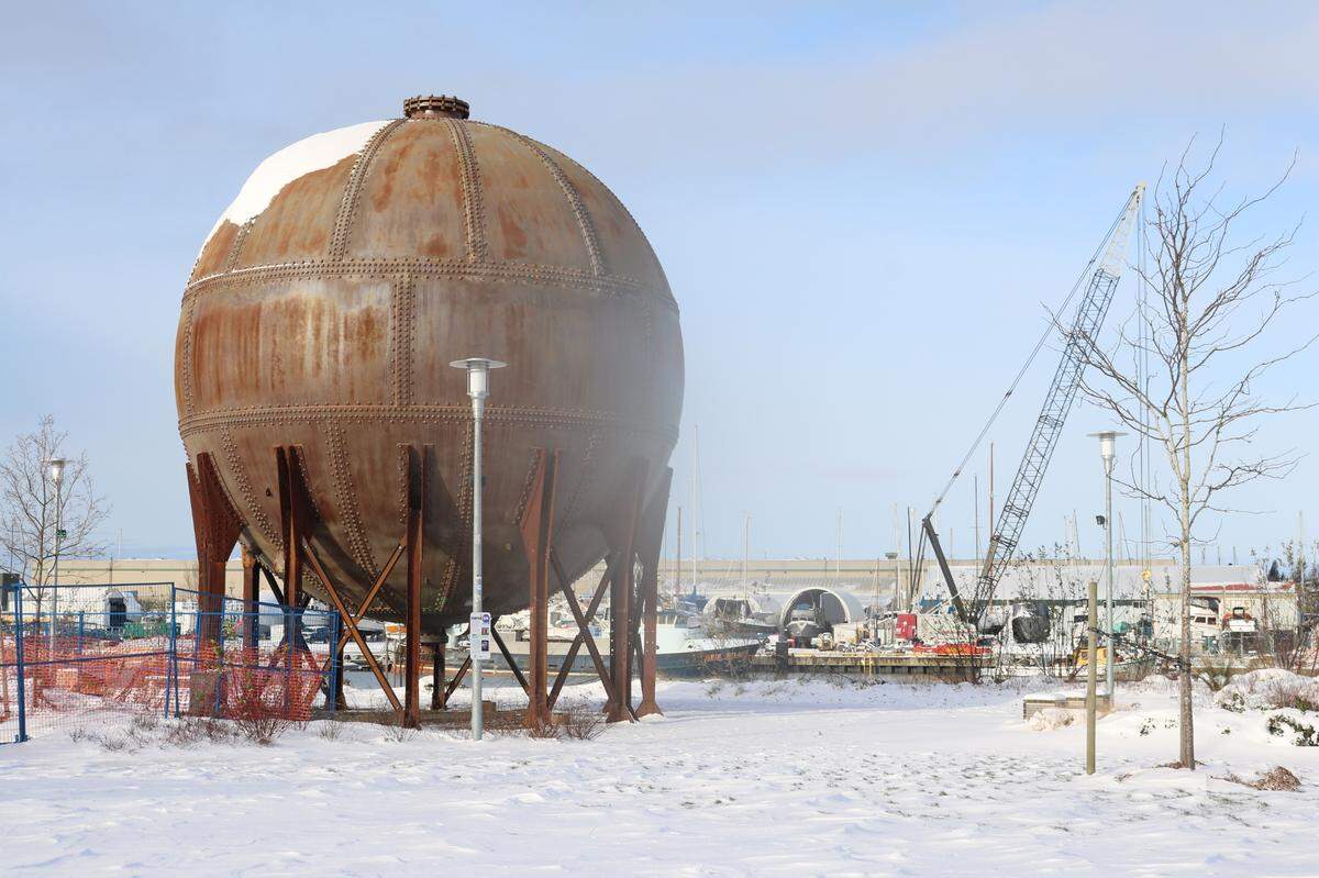Snow caps the acid ball, a waterfront industrial artifact, Monday morning, Dec. 27, at Waypoint Park on Granary Avenue in downtown Bellingham.