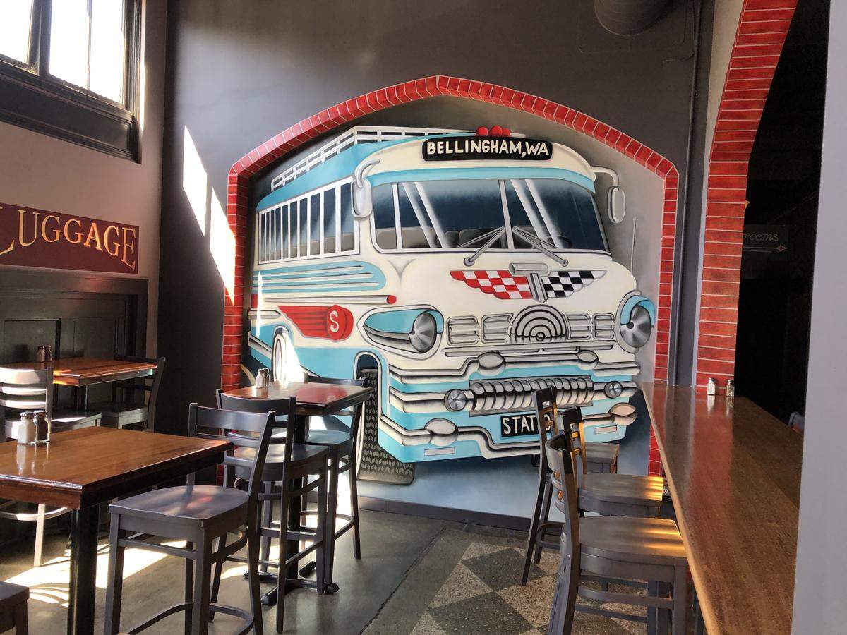 The inside of the Station Social House, which opened in summer 2019 in Bellingham has murals depicting it as a transportation hub.