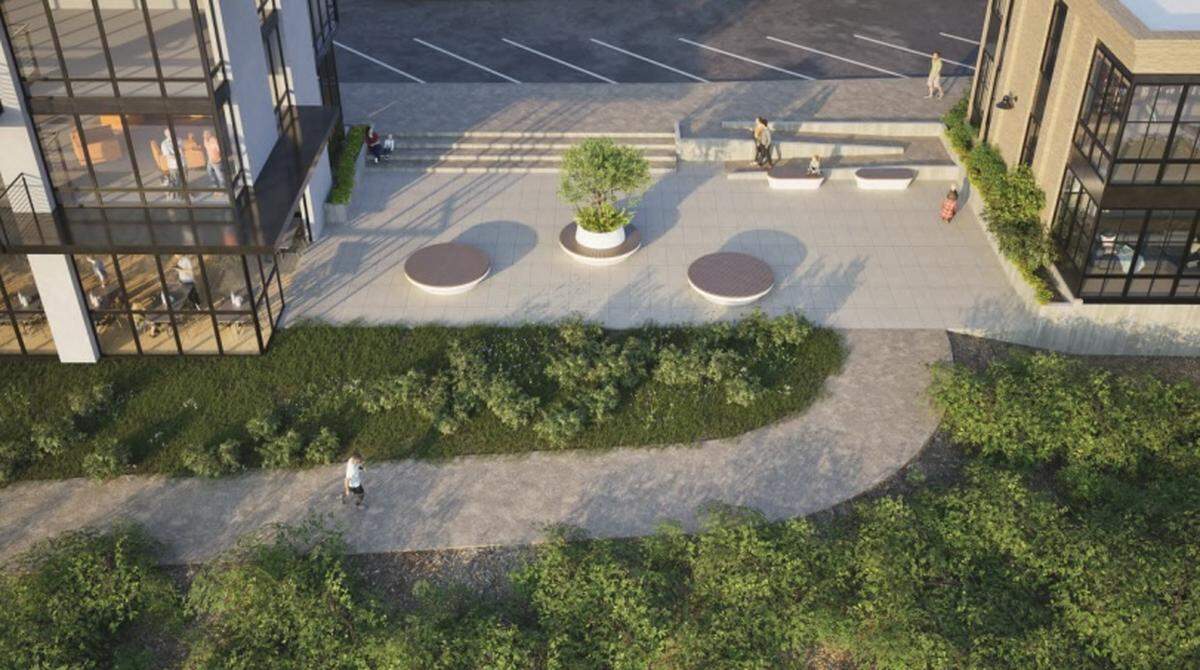 A concrete, public park plaza is proposed between the two buildings.