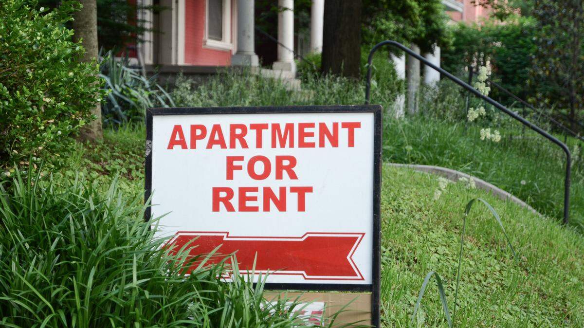 Apartment for rent sign displayed on residential street. Shows demand for housing, rental market, landlord-tenant relations.