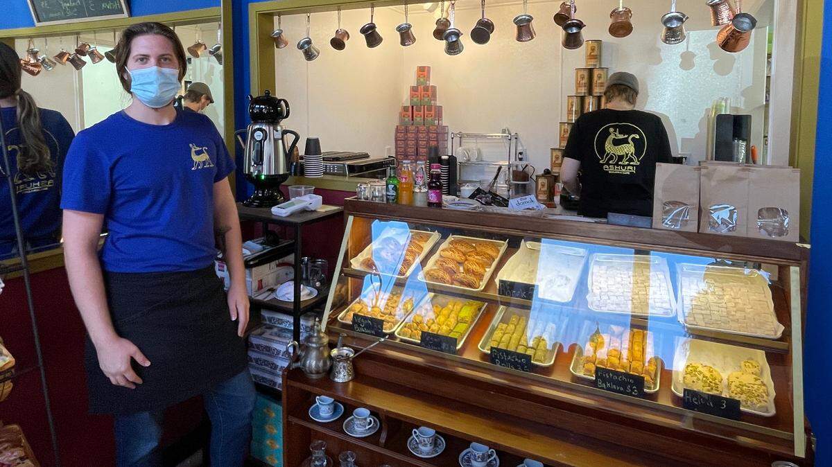 Kristofer Konutgan, left, and his brother Lukas opened Ashuri Baklava & Cafe in downtown Bellingham, Wash., in October 2021, offering Turkish coffee, baked goods as well as marketplace products such as carpets, coffee pots and lamps.