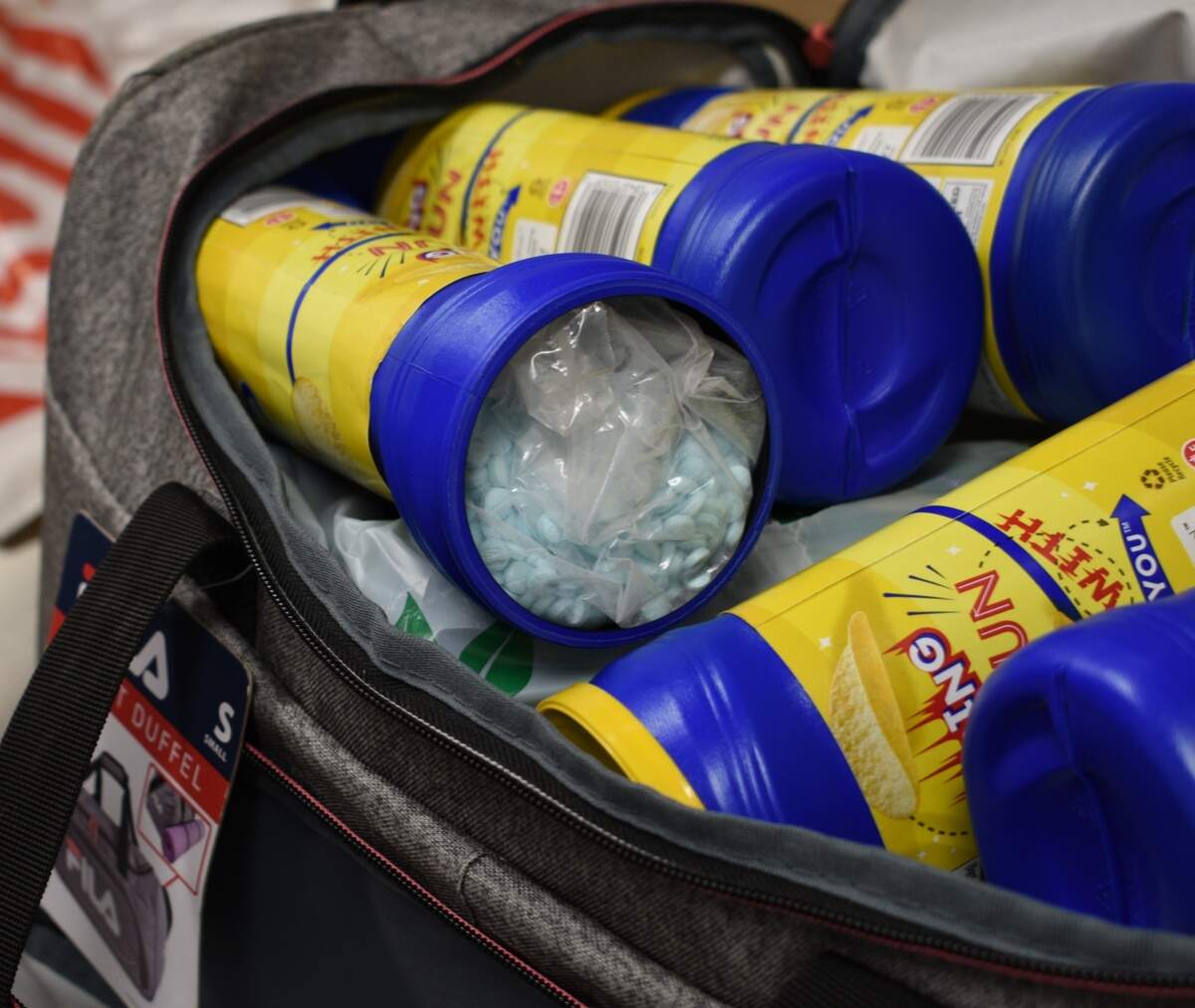Some of the approximately 91,000 fentanyl pills that were delivered to Bellingham, according to Homeland Security Investigations. Two men were indicted Friday, July 22, in the Western District of Washington for drug trafficking offenses related to the distribution and sale of fentanyl pills. Approximately 10 kilograms of fentanyl was concealed within cardboard boxes and potato chip containers found in a duffle bag by Homeland Security Investigations special agents.