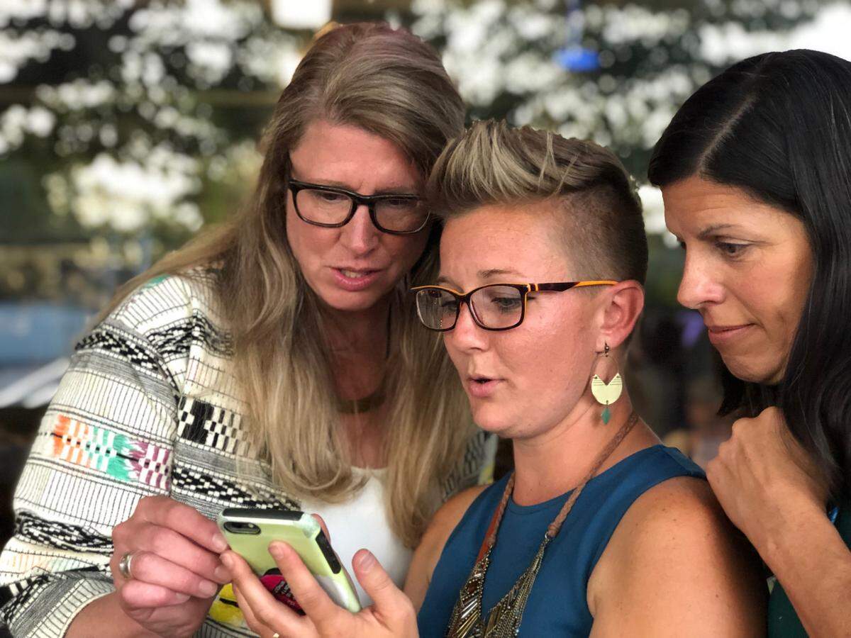 Mayoral candidate April Barker, left, reviews preliminary election numbers at Greene’s Corner in Bellingham Aug. 6.