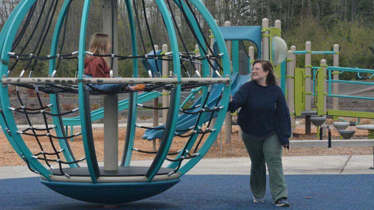 Angela Watson and her daughter Lottie, 6, enjoy a spinning play structure at Cordata Park, which is mostly accessible to people with mobility difficulties, on April 26.