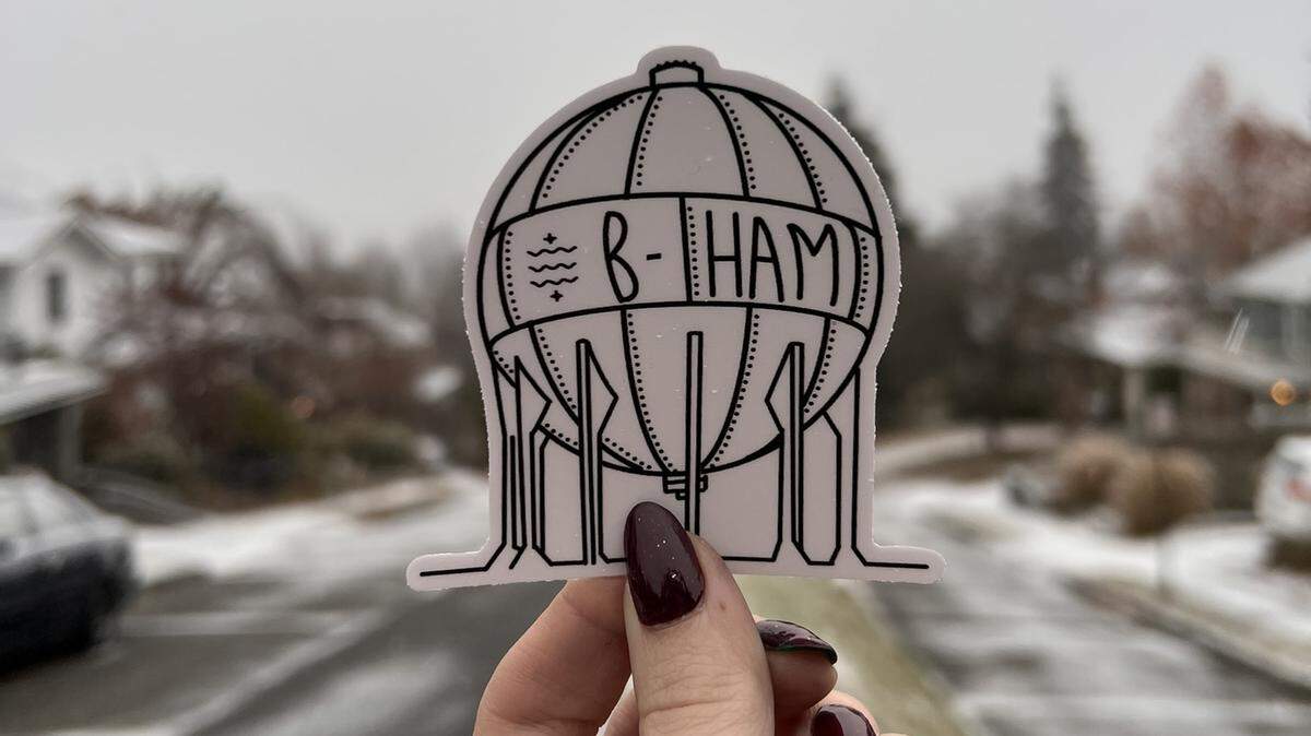 Tabitha Smed holds one of her acid ball stickers that, along with other printed designs, are for sale on her Etsy store.
