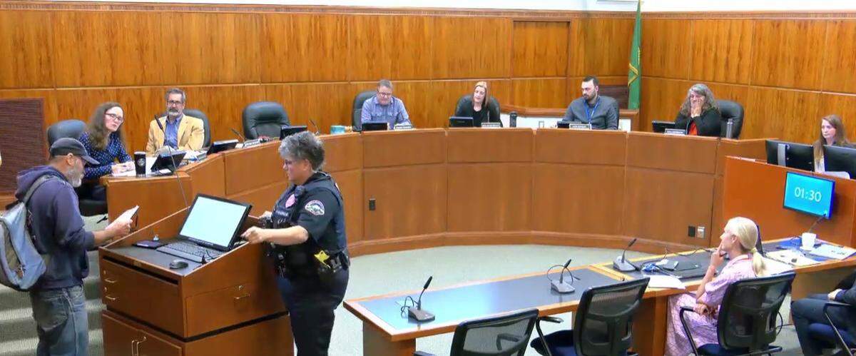 In this screenshot from video, Bellingham Mayor Kim Lund, right, and members of the City Council watch as police Lt. Claudia Murphy tells a speaker who gave his name as “Nobody No One” during a 2024 meeting that he had violated the rules of open public comment. Murphy escorted the speaker out of Council Chambers.