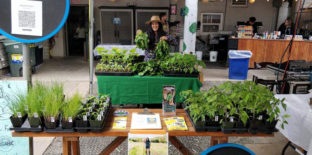 Savannah Flynn, a farmer in the Incubator Farm Program, sells some of her crops at a market after it was grown on farmland in Everson, Wash.