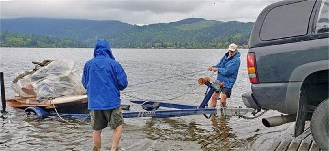 Lake Samish community members haul Styrofoam for disposal at a cleanup event out of the lake south of Bellingham, Wash., in early May 2021.