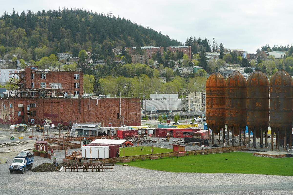 The Trackside Beer Garden sits next to the iconic digester tanks on April 11, 2025, in Bellingham, Wash. The tanks, known locally as the “rocket ships,” have remained on the waterfront property since it was the Georgia-Pacific pulp and paper mill.