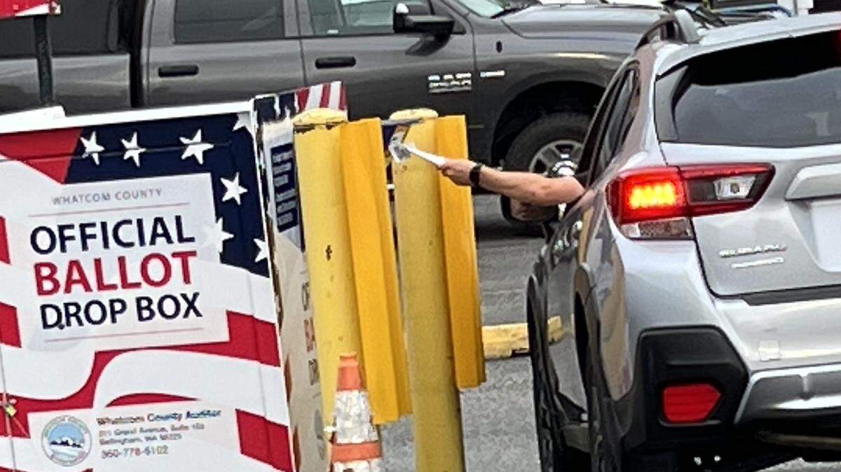 A voter leaves a primary ballot in the drop box outside the Whatcom County Courthouse in Bellingham, Wash., on Election Day, Tuesday, Aug. 6, 2024.