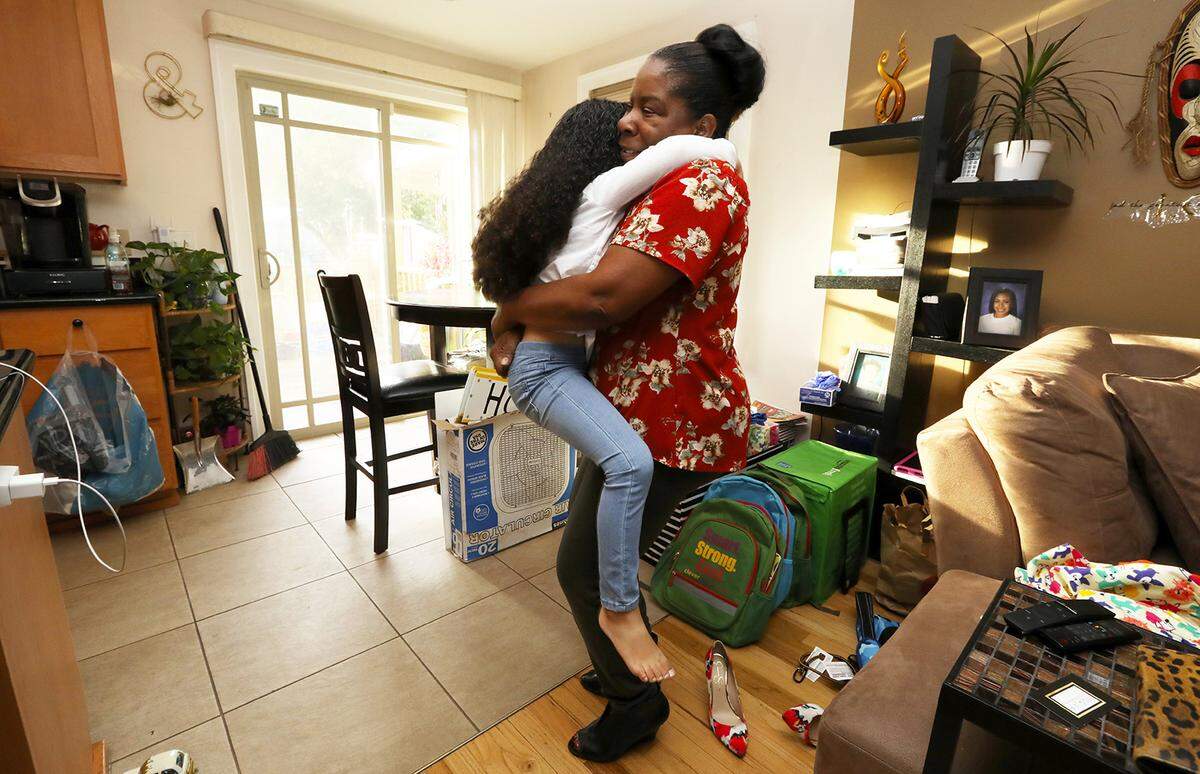 Alesia Cannady gets a hug from her 4-year-old granddaughter Aleiyah Cannady, who wants to be picked up by the soon-to-be 65-year-old, in September 2018 in Seattle. Alesia has a standard reply to those who ask what she’ll do in her situation, raising a child later in life: “Whatever I’m going to do, I’m going to do it with her.”