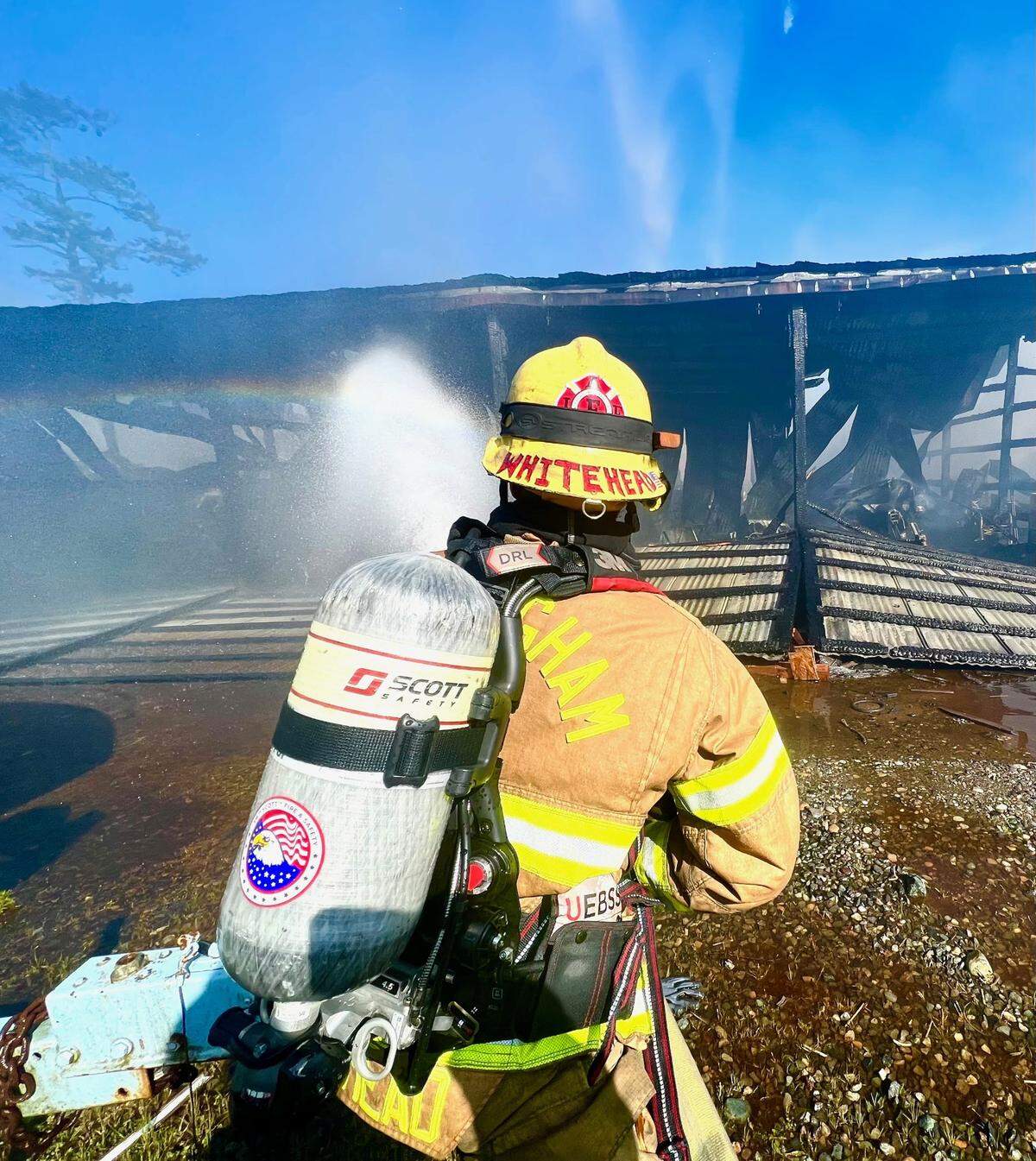 Firefighters battle a fire at a boatyard on Gooseberry Point near Bellingham on Tuesday, April 10. The fire destroyed the building and the boats and fishing gear stored inside, causing an estimated $2.5 million in damage, but no serious injuries were reported.