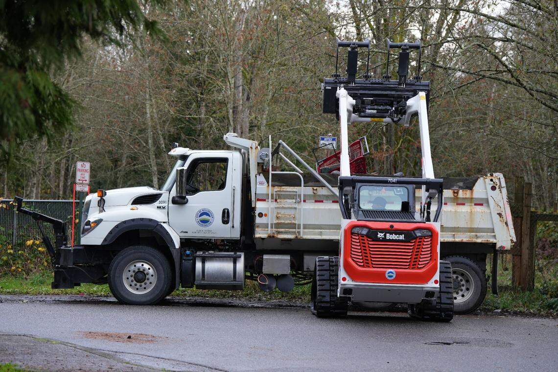 City crews used machinery to clear larger items like shopping carts from the encampment behind Walmart.