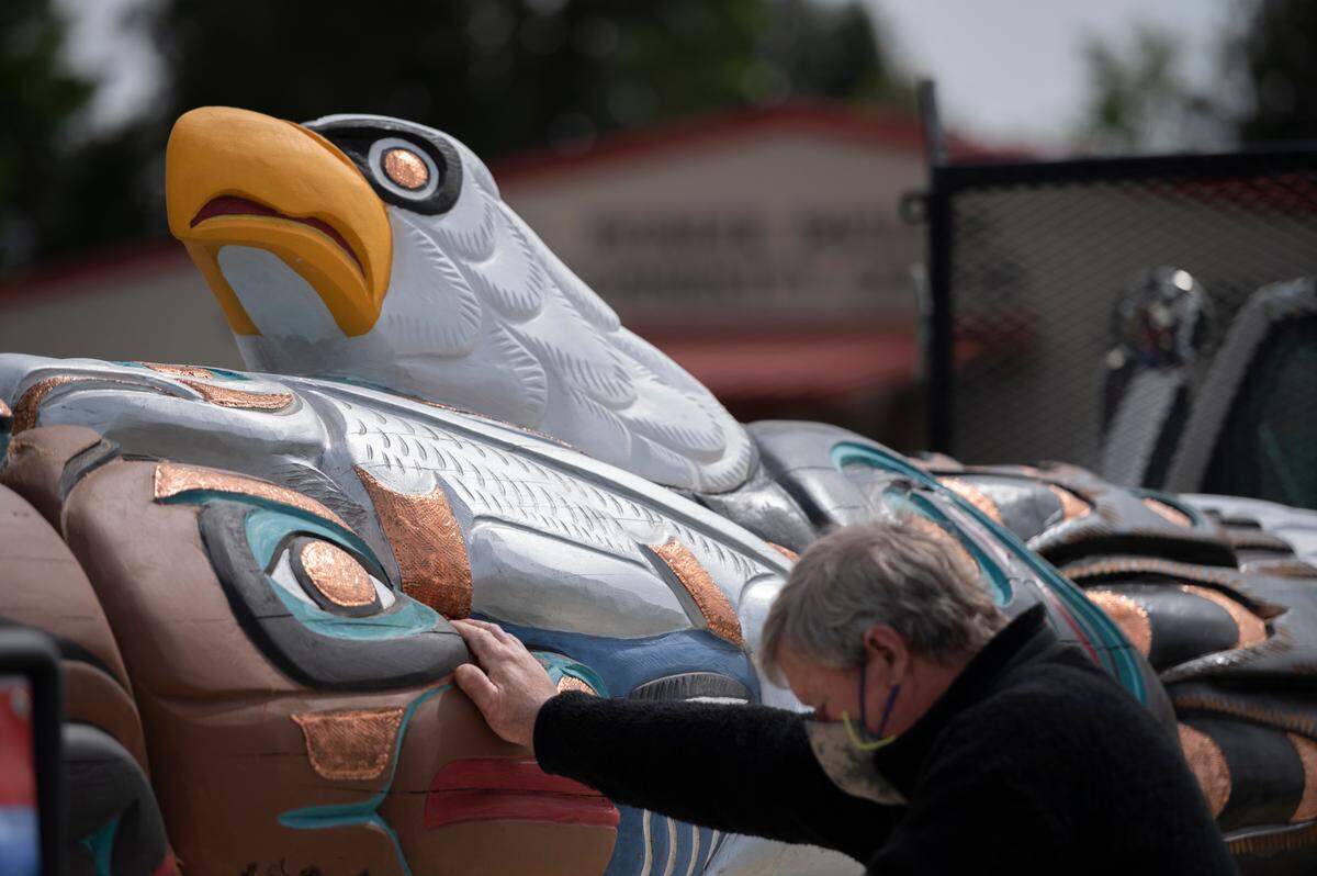 A visitor admires Jewell James’ totem pole during a small ceremony on Wednesday, May 5, in Ferndale. The pole will make a journey across the county visiting sacred sites and bringing awareness to the importance of protecting sacred lands.