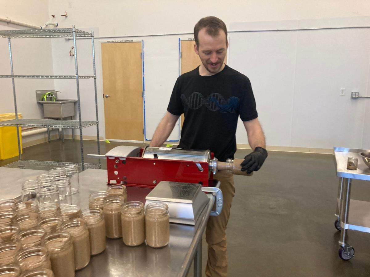 Nicholas Sotak fills a jar with a butter spread. He is the co-owner of LEAP, which makes nut butter spread products in Bellingham.