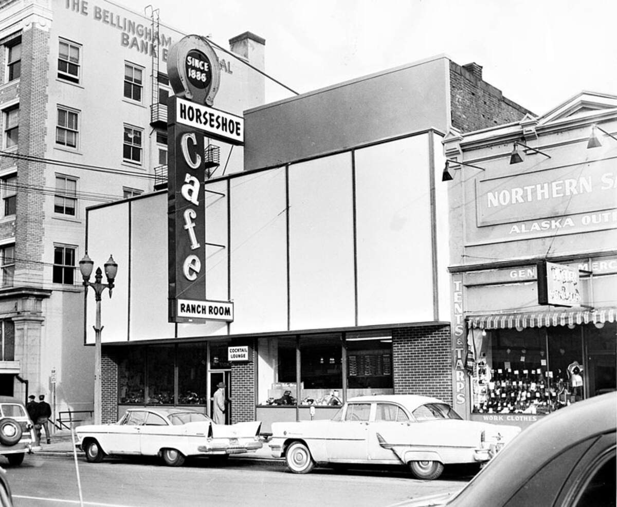 This 1958 photograph shows the venerable Horseshoe Café, which, according to its owners, opened on Holly Street in 1886 — three years before Washington became a state. Originally a saloon, the Horseshoe early on also sold cigars, tobacco, hunting supplies and tackle. The business was first located in one, and then another, site on the south side of Holly Street, before moving across the street to its current location at 113 E. Holly St. in 1958.