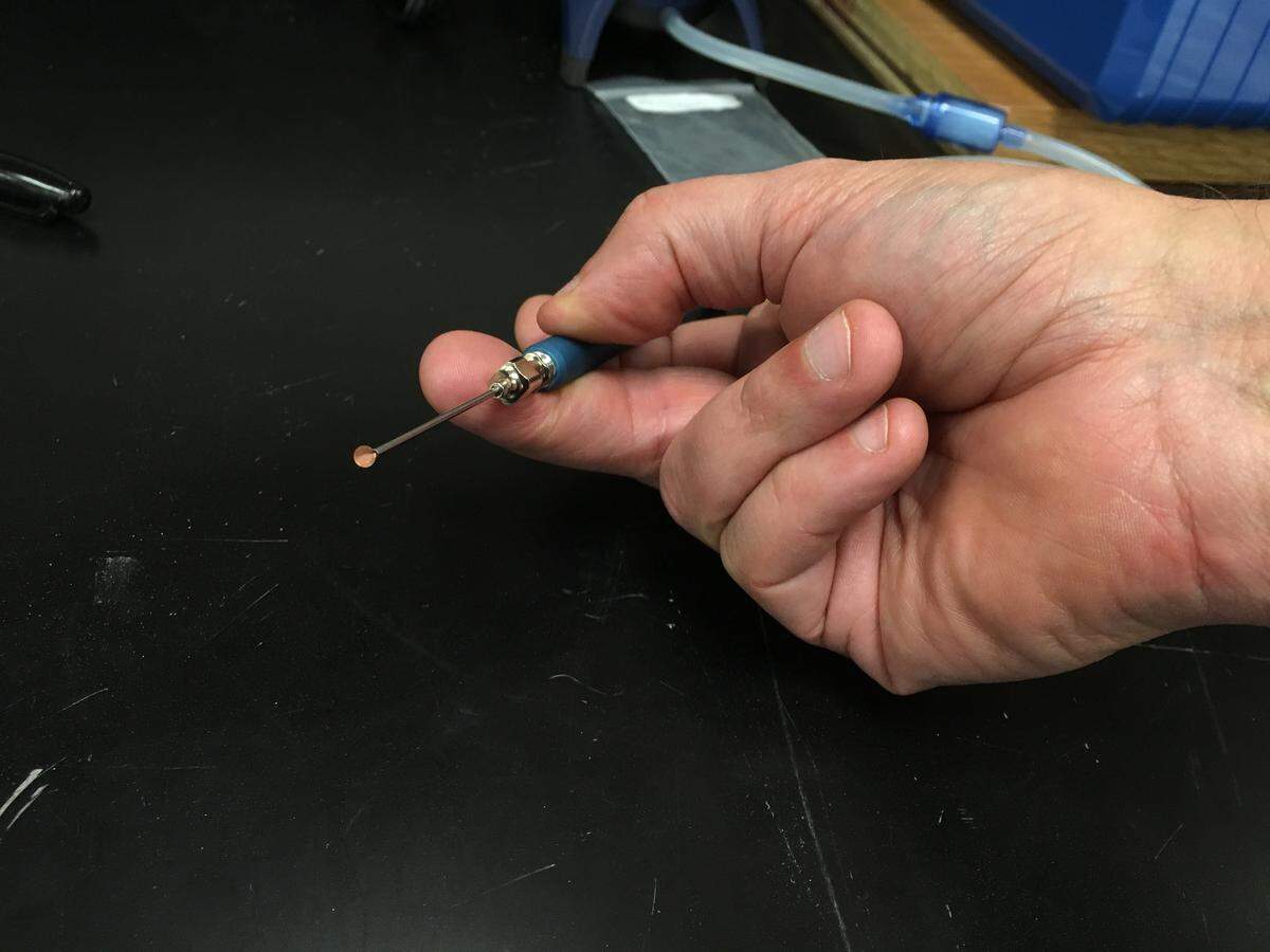 An amorphous carbon support grid held the particles of soot and tar for examination under an electron microscope.