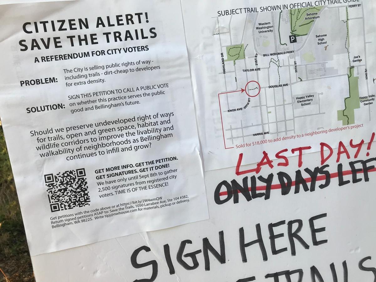 A sign asks passers-by to sign a petition left at Taylor Dock in Bellingham, Wash., on Tuesday, Sept. 7.