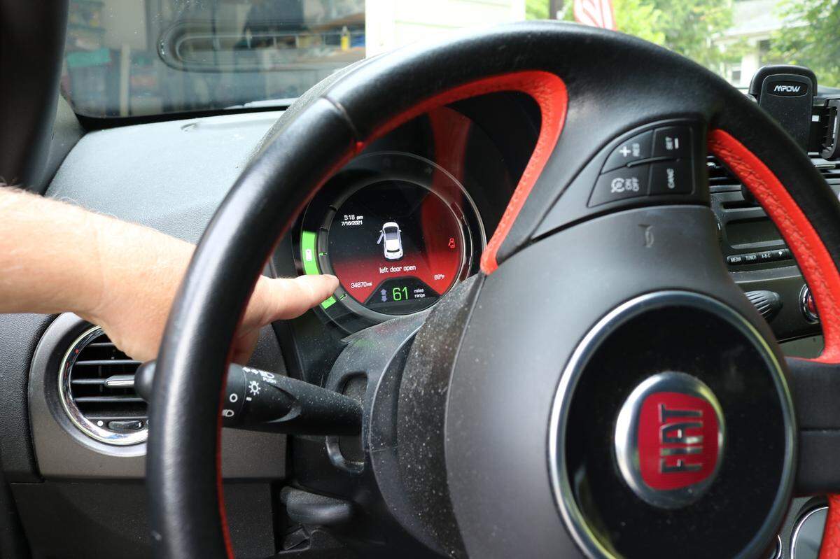 Don Minter, a resident of Bellingham, points to the dashboard of his electric vehicle, which shows how much battery life the car has, on Friday, July 16.