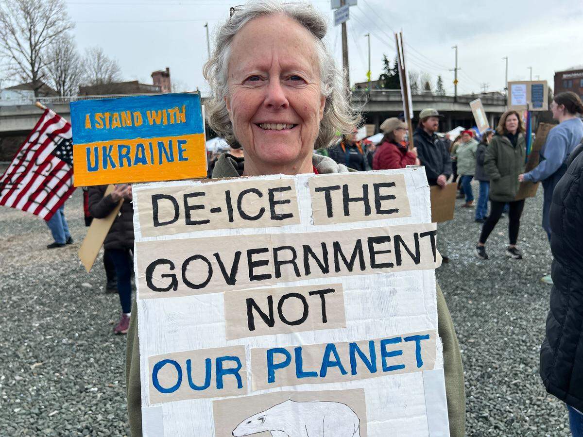 Krista Hunter of Bellingham holds up her protest sign Saturday, March 28, 2026 during a local No Kings protest event in Bellingham.