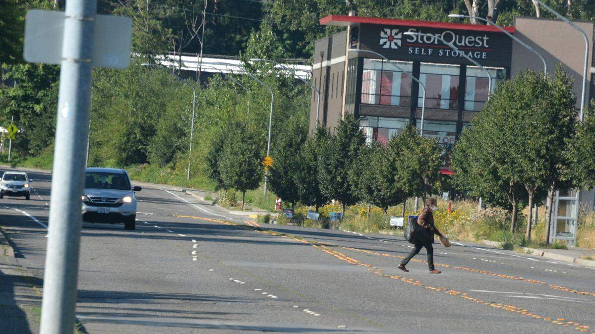 A pedestrian crosses against traffic near where a new crosswalk is planned at the intersection of Lincoln Street and Viking Circle on Thursday.