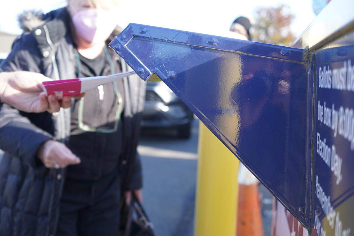 A voter drops their ballot in an official drop box near the Whatcom County Courthouse on Election Day, Tuesday, Nov. 8, in Bellingham.